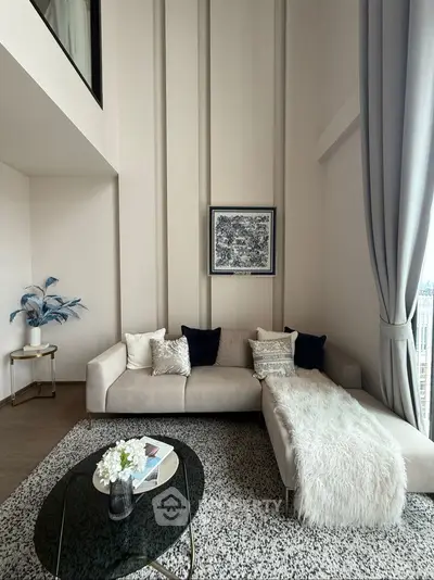 Luxurious modern living room with high ceilings and elegant decor