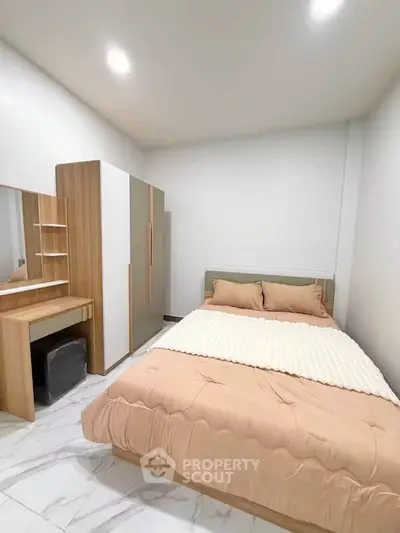 Cozy bedroom with modern furniture and soft lighting, perfect for relaxation.