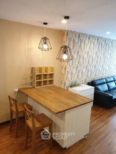 Stylish modern living room with wooden flooring and chic lighting