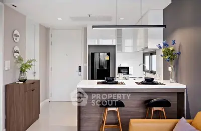 Modern kitchen with sleek design and open layout, featuring a stylish breakfast bar and contemporary decor.