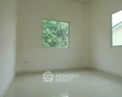 Bright empty room with large windows and tiled floor, ready for customization.