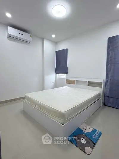 Modern minimalist bedroom with air conditioning and cozy decor