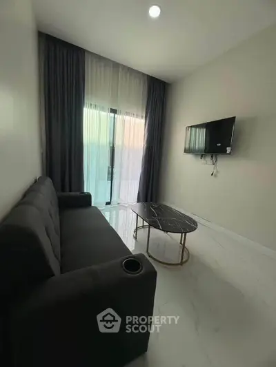 Modern living room with sleek sofa, wall-mounted TV, and elegant marble coffee table.