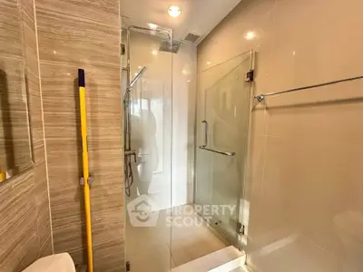 Modern bathroom with glass shower enclosure and sleek tile design