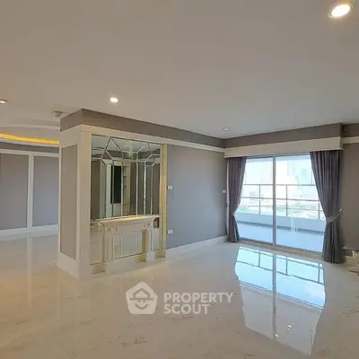 Spacious modern living room with large windows and elegant flooring