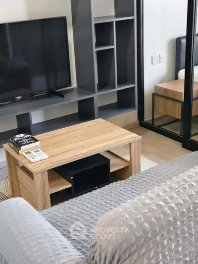 Modern living room with cozy sofa and sleek TV setup