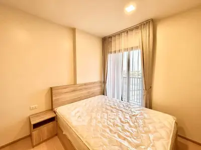 Bright and cozy bedroom with large window and modern furnishings