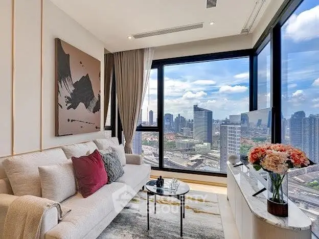Luxurious living room with stunning city view, modern decor, and elegant furnishings.