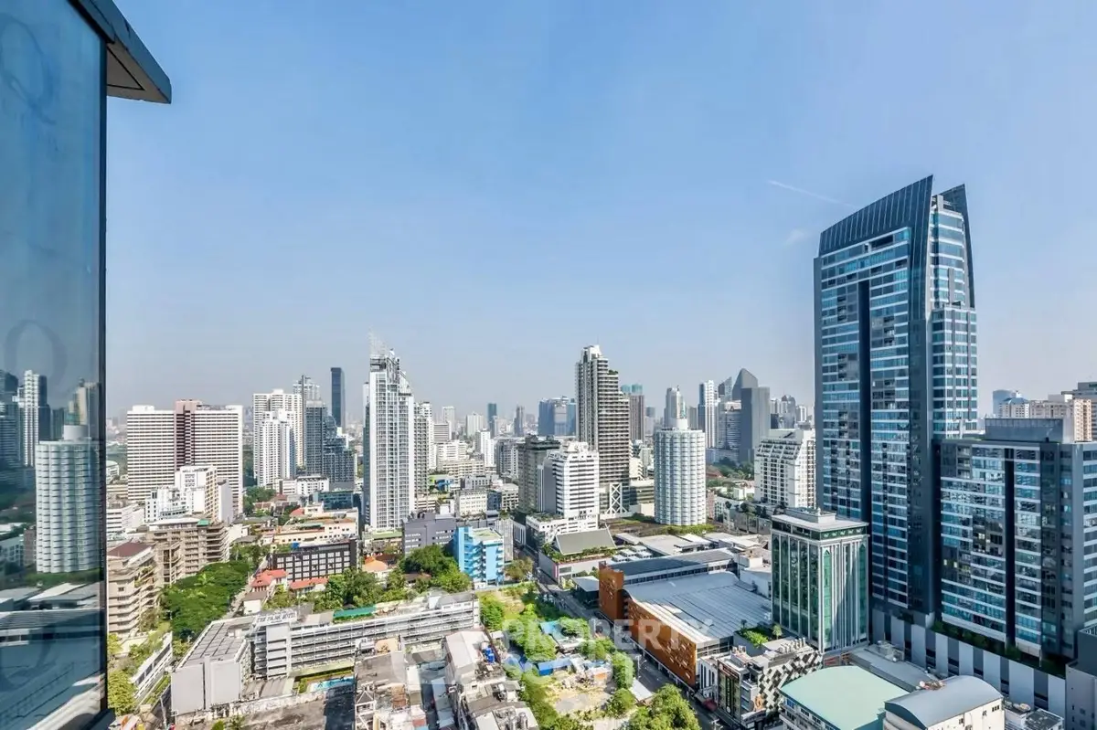 Stunning cityscape view from a high-rise building showcasing modern architecture and vibrant urban life.