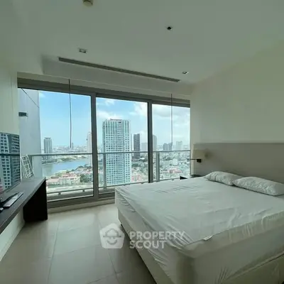 Spacious bedroom with stunning city view and large windows
