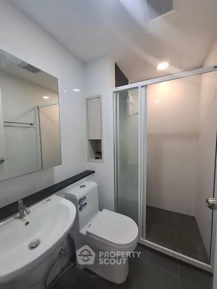 Modern bathroom with sleek fixtures and glass shower enclosure