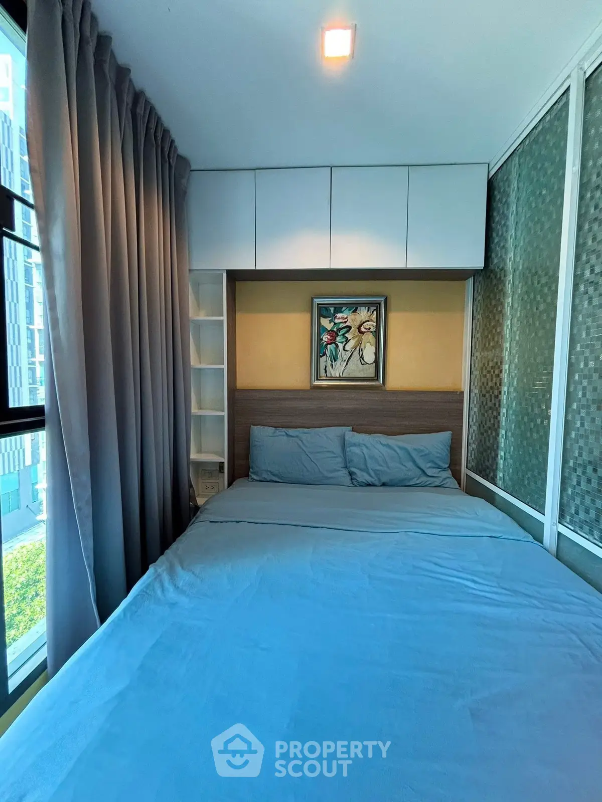 Cozy modern bedroom with large window and stylish decor in urban apartment