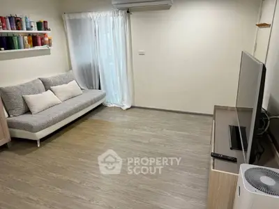 Modern living room with sleek sofa, TV setup, and stylish decor.