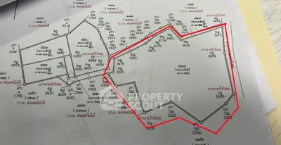 Detailed schematic plan with property boundaries and measurements in red outline.