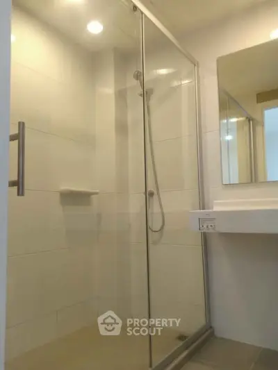 Modern bathroom with glass shower enclosure and sleek design