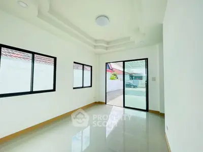 Bright and airy room with large windows and modern ceiling design