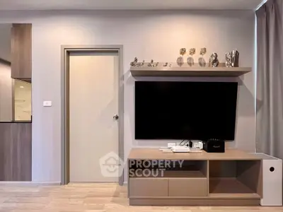 Modern living room with sleek TV unit and decorative accents, showcasing contemporary interior design.