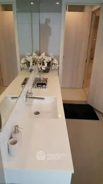 Modern bathroom with sleek vanity and elegant decor in a contemporary home.
