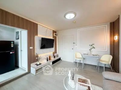 Modern living room with stylish decor and open layout, featuring a sleek TV setup and cozy dining area.