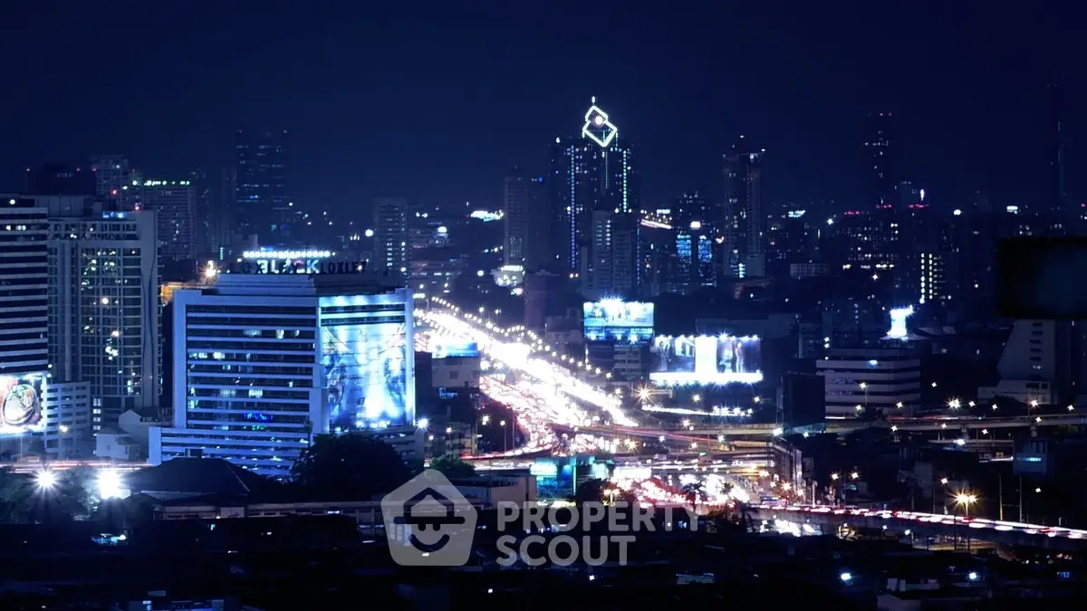 Stunning night cityscape with illuminated skyscrapers and bustling streets.