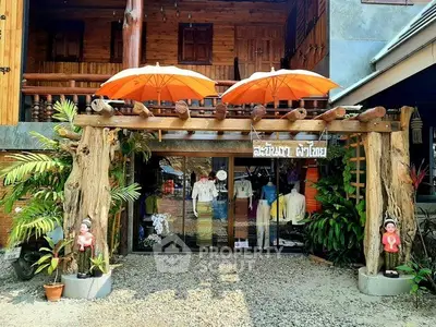 Charming rustic storefront with wooden accents and vibrant orange umbrellas.