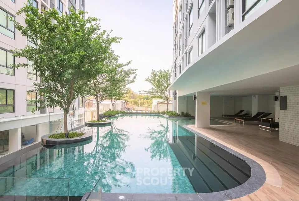 Luxurious modern apartment pool area with sleek design and lush greenery