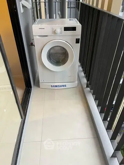 Compact balcony with a Samsung washing machine, ideal for urban living.