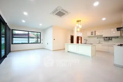 Spacious modern kitchen with open layout and ample natural light, perfect for family gatherings.