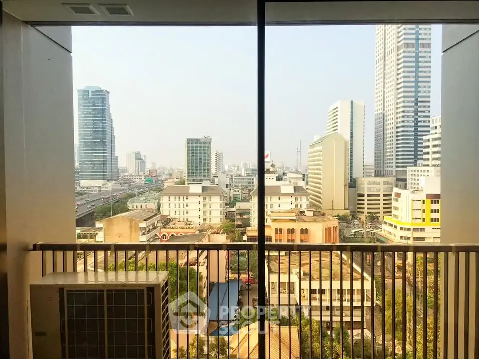 Stunning cityscape view from a high-rise balcony with modern urban skyline.