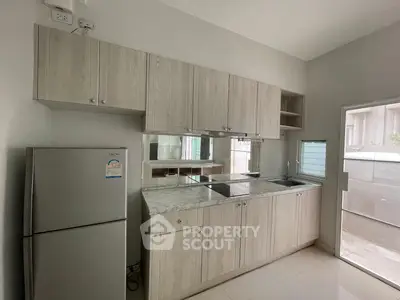 Modern kitchen with sleek cabinetry and marble countertops in a bright, airy space.