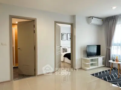 Modern apartment interior with bedroom, living area, and air conditioning.