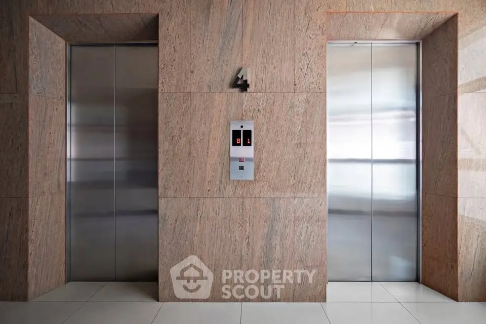Modern building elevator lobby with sleek design and polished metal doors.
