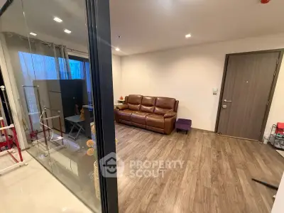 Modern living room with wooden flooring and leather sofa in a cozy apartment
