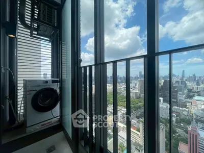 Stunning high-rise balcony view with cityscape and washing machine, perfect for urban living.
