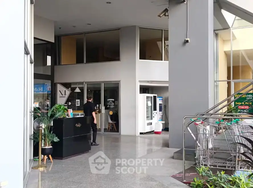 Modern commercial building entrance with sleek design and shopping carts