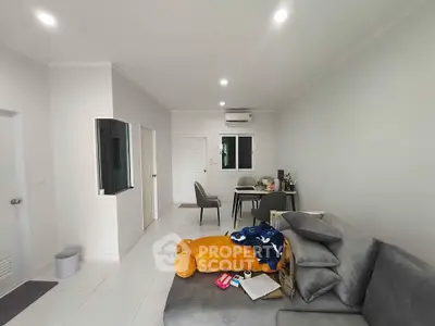Modern living room with cozy gray sofa and minimalist decor