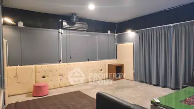 Spacious modern living room with unique wall design and cozy ambiance.