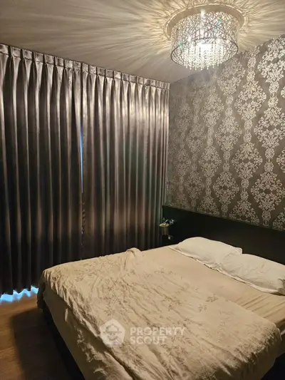 Luxurious bedroom with elegant wallpaper and chandelier lighting