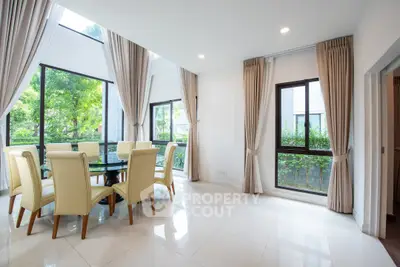 Spacious dining area with large windows and elegant decor in modern home