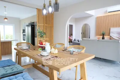 Spacious open-plan dining and living area with modern decor and natural light.