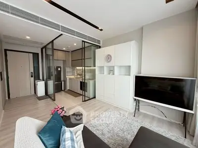 Modern living room with open kitchen layout and stylish decor