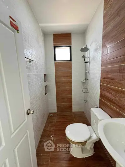 Modern bathroom with wood accents and sleek shower design