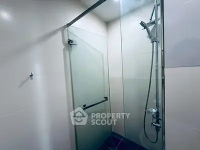 Modern bathroom with glass shower enclosure and sleek fixtures