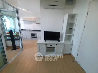 Modern living room with open kitchen and sleek wooden flooring