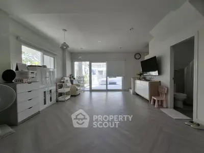 Spacious modern living room with large windows and stylish decor