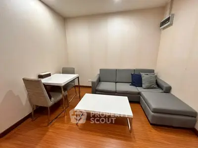 Modern living room with sleek furniture and wooden flooring