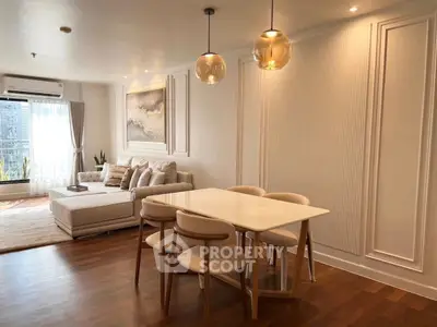 Elegant living room with modern dining area and stylish lighting