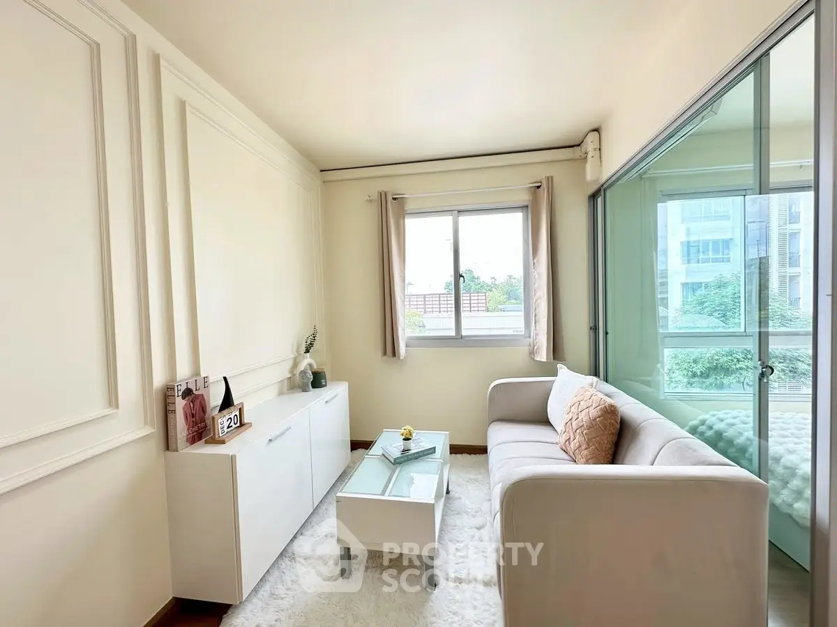 Charming living room with cozy sofa and natural light, perfect for relaxation.