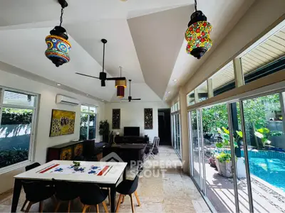 Spacious living room with pool view and elegant decor in modern home