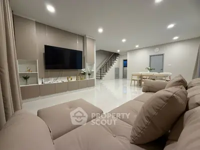 Spacious modern living room with plush seating and sleek decor, perfect for relaxation and entertainment.